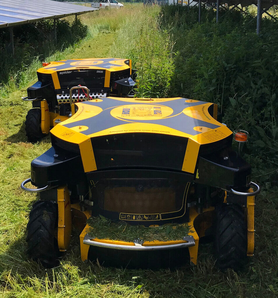 SPIDER 2SGS EFI mowers in grass near solar panels