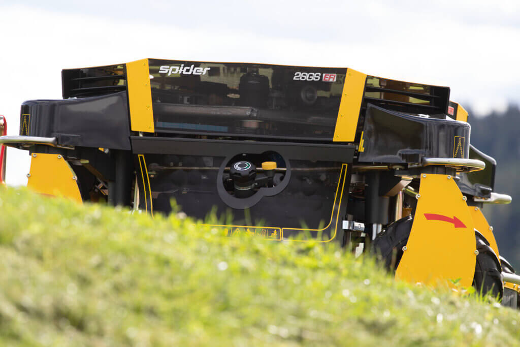 A close-up of the back of the best mower for steep slopes, the SPIDER 2SGS EFI, on the grass.