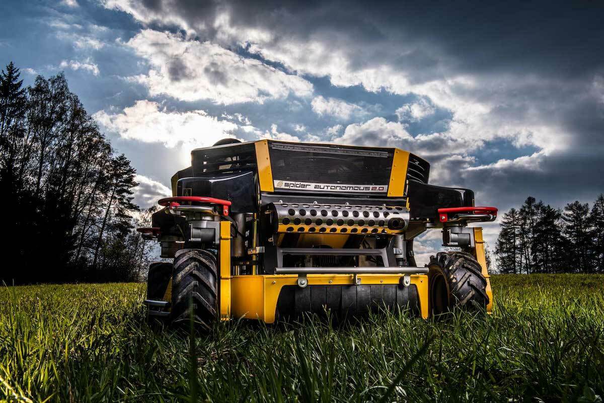 The innovative SPIDER Autonomous 2.0 mower set against a cloudy sky, emphasizing its modern and autonomous functionality.
